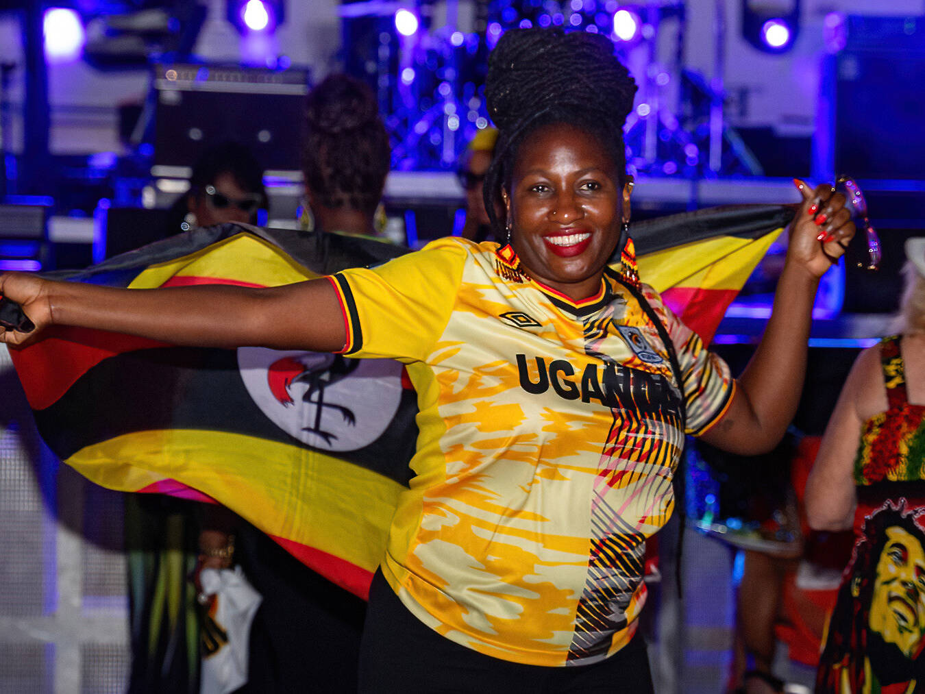Theme nights on Welcome to Jamrock Reggae Cruise. Woman holding her country flag